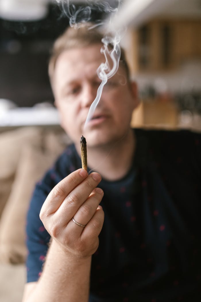 Man in Black Shirt Holding a Cigarette