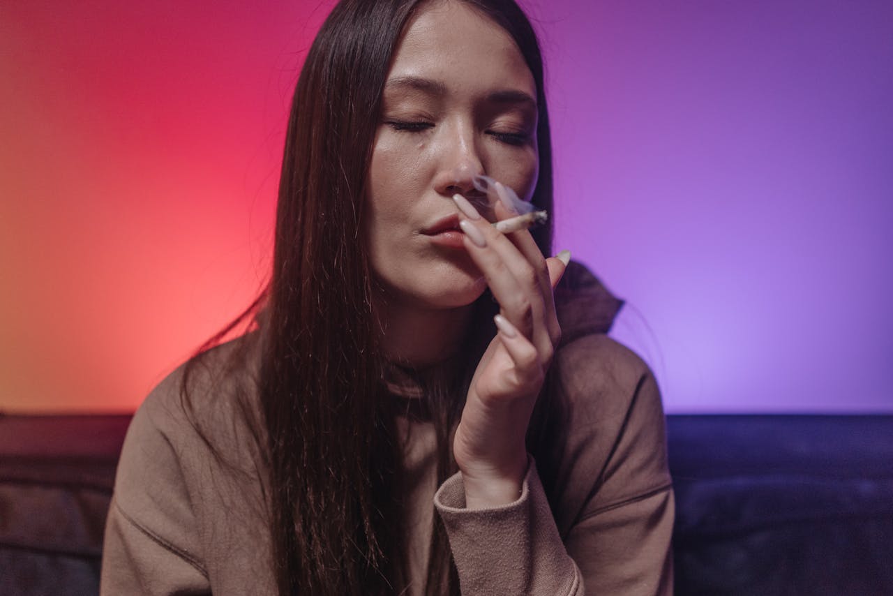 A Woman Smoking with Her Eyes Closed